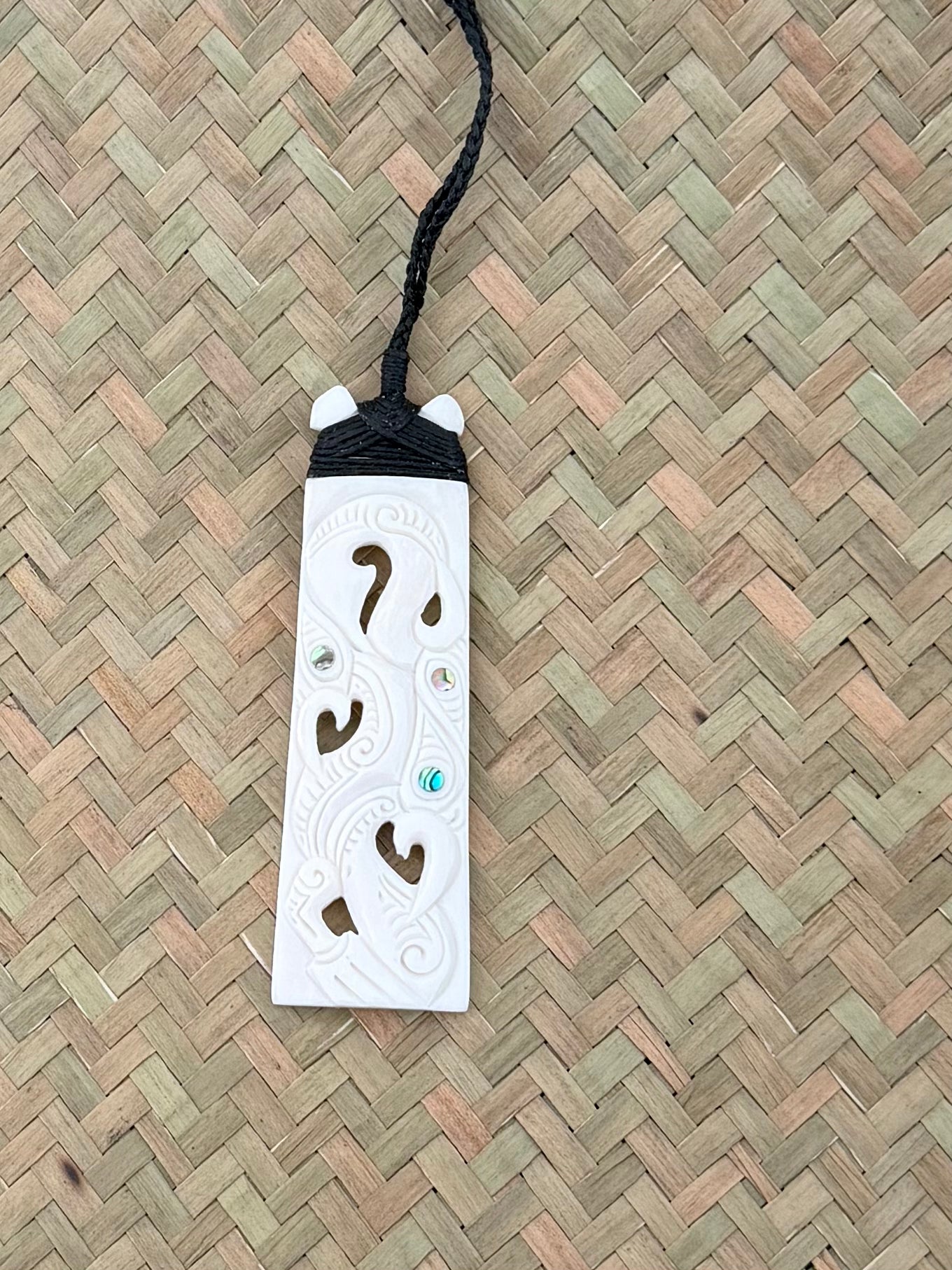 Carved toki beef bone pendant