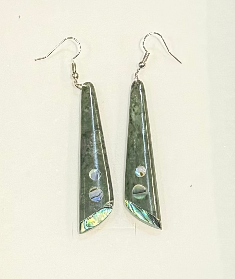 Pair of Greenstone triangular earrings on a white background