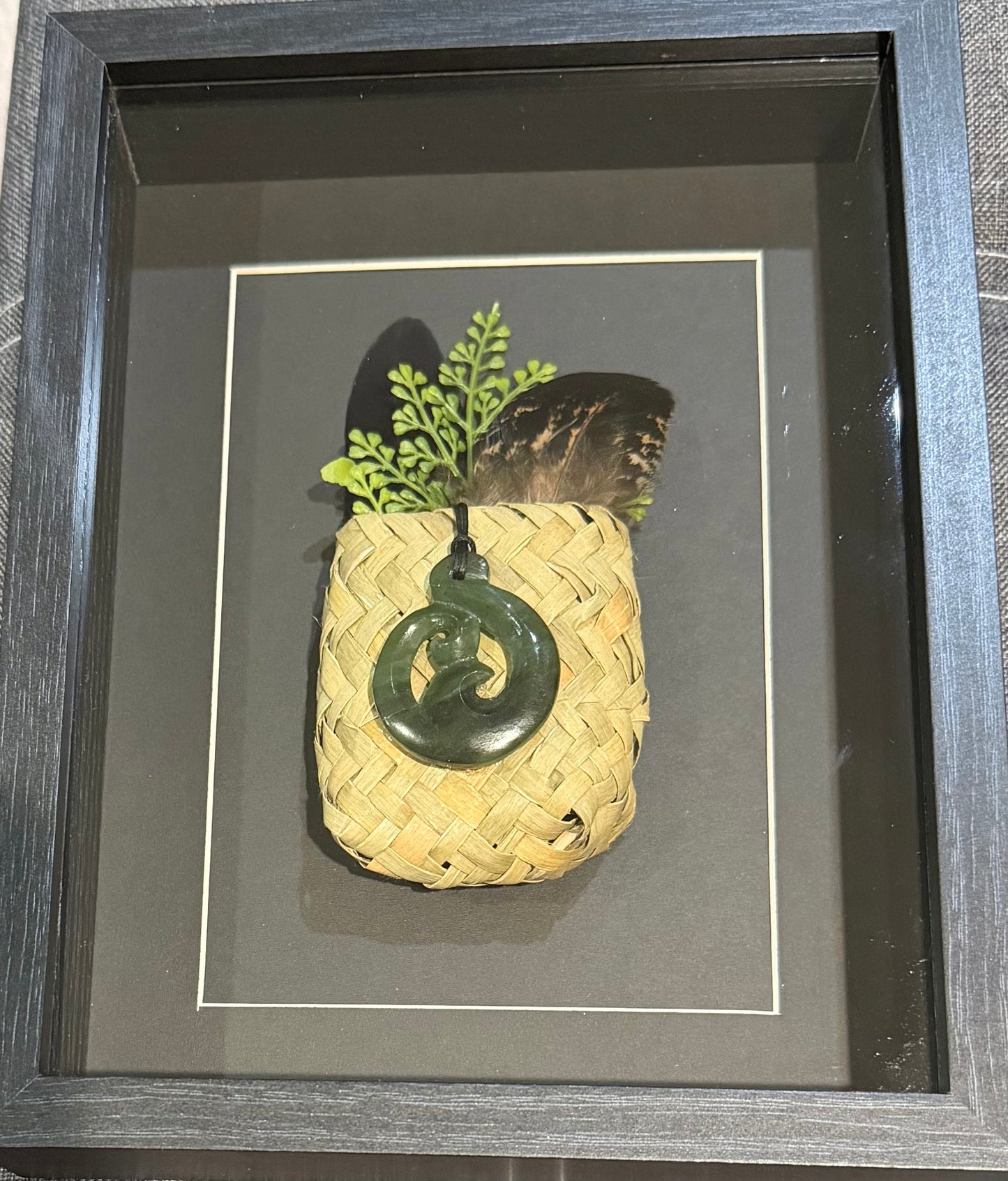 Greenstone Koru Twist in a Kete with Feathers Framed
