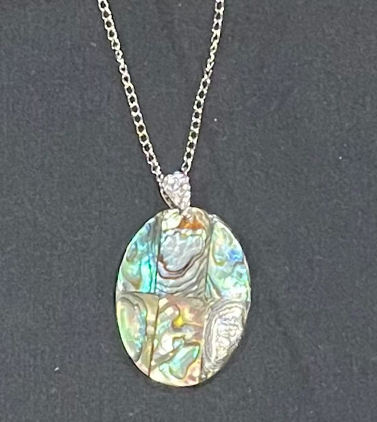 Necklace with an abalone shell pendant on a dark background