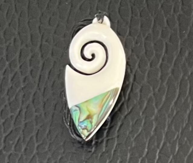 Koru bone Pendant with spiral design and abalone shell on a textured black background