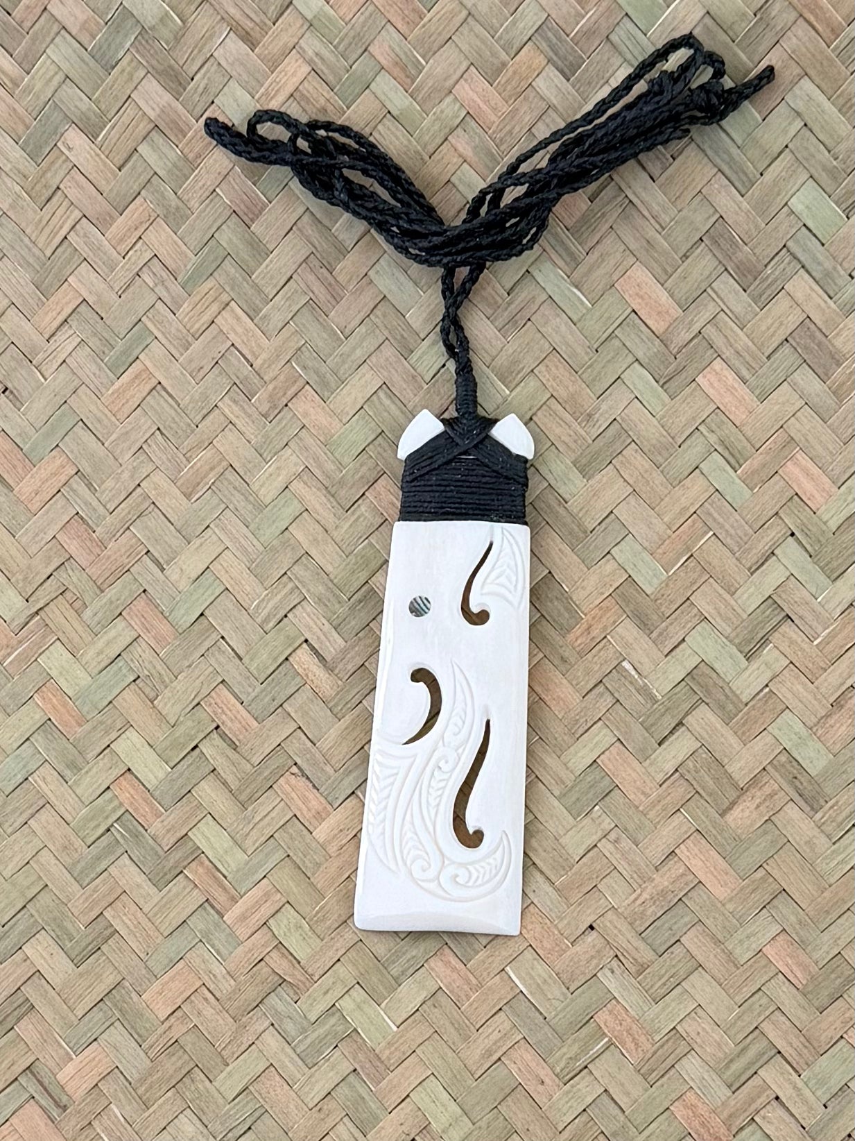 Carved toki beef bone pendant