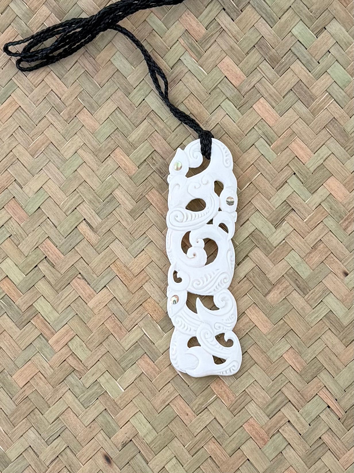 Carved beef bone pendant Manaia