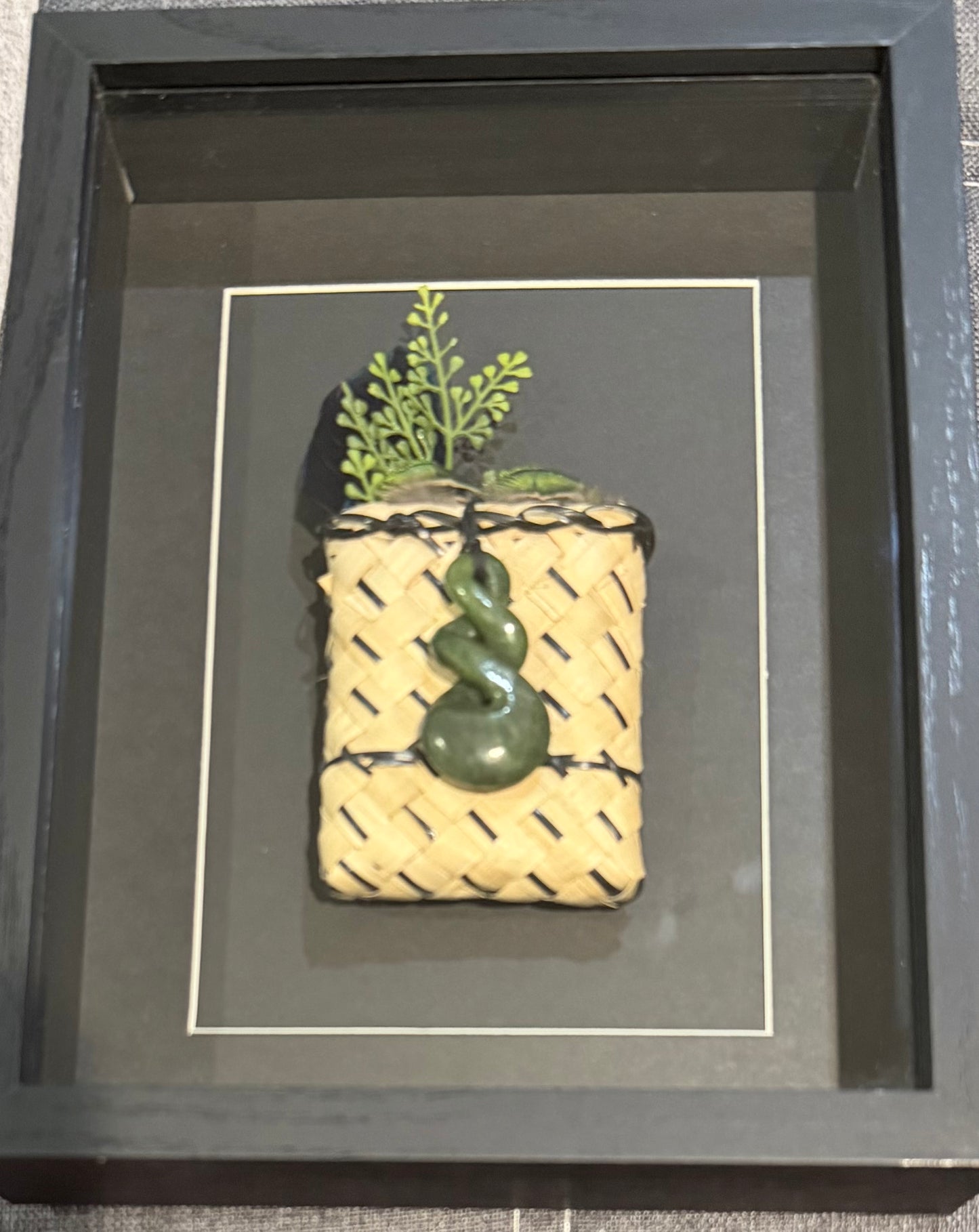 Kete with greenstone twist and feathers Framed