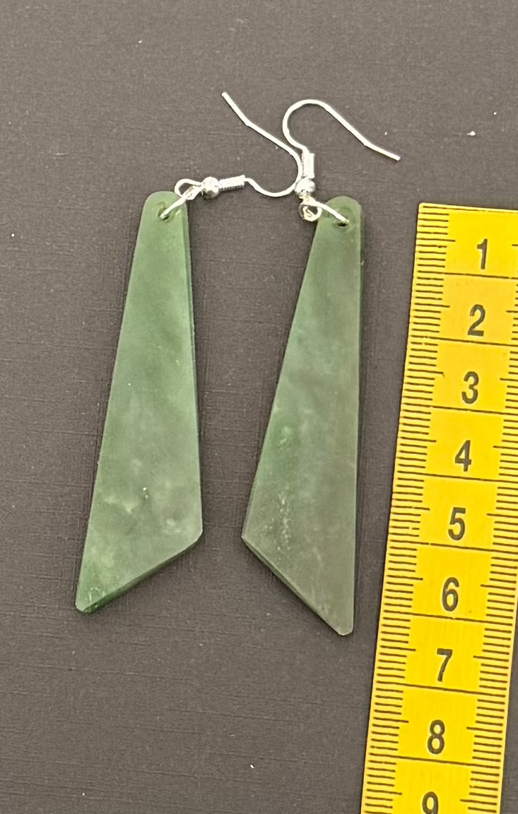 Greenstone earrings with silver hooks on a gray background, accompanied by a yellow ruler for scale.