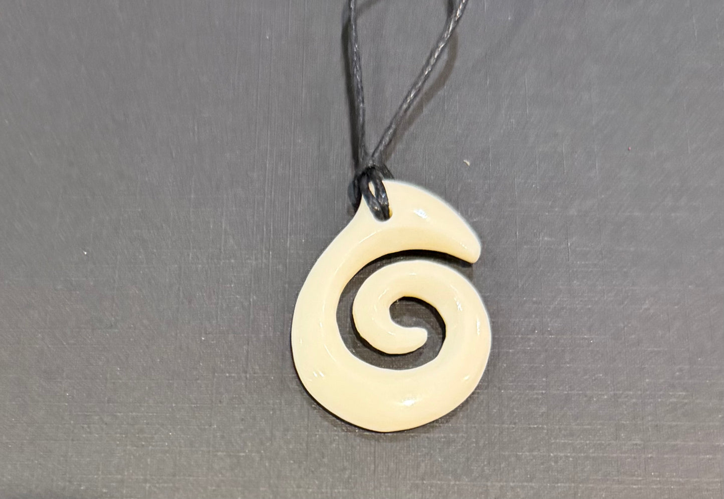 Beef bone koru pendant
