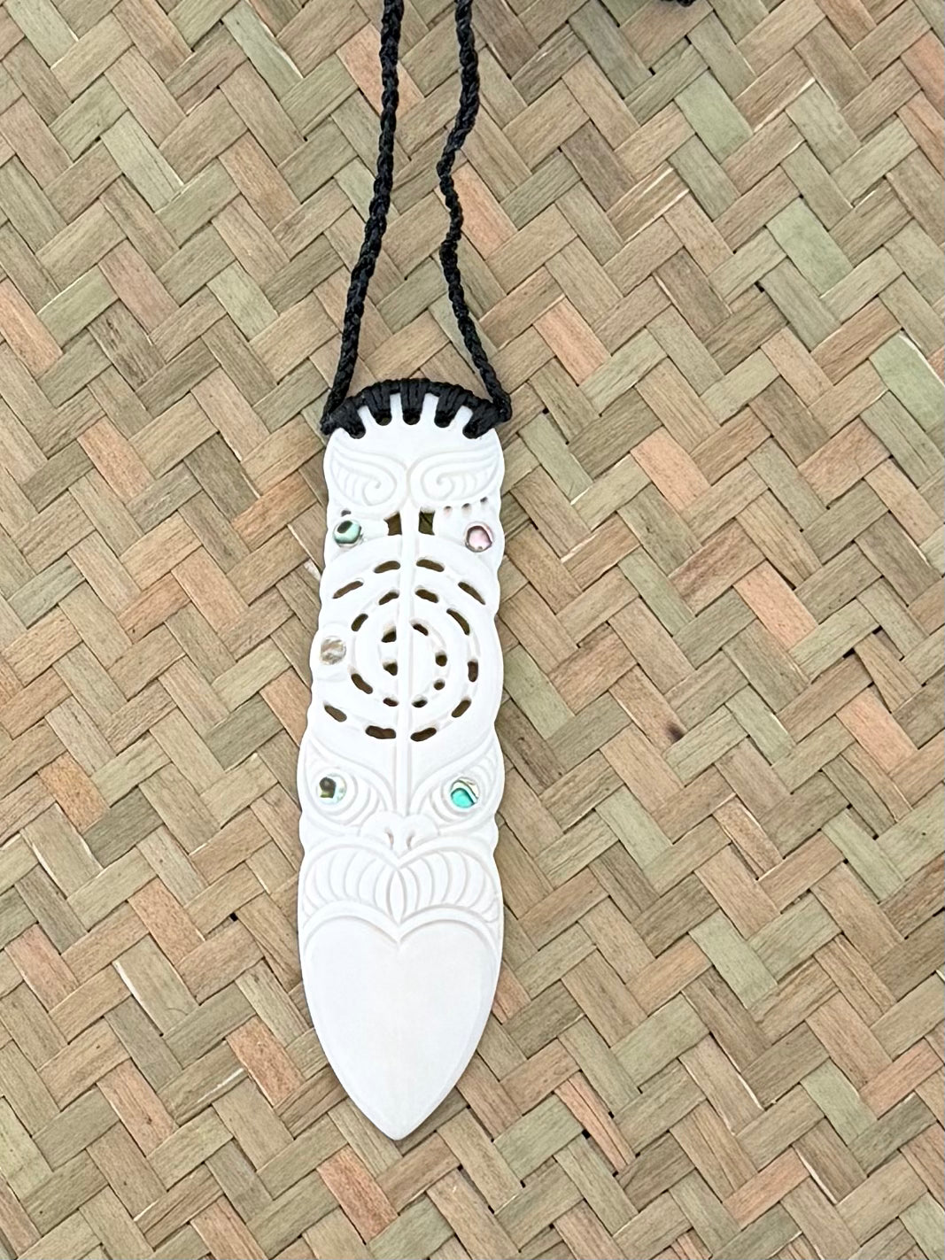 Carved toki face beef bone pendant