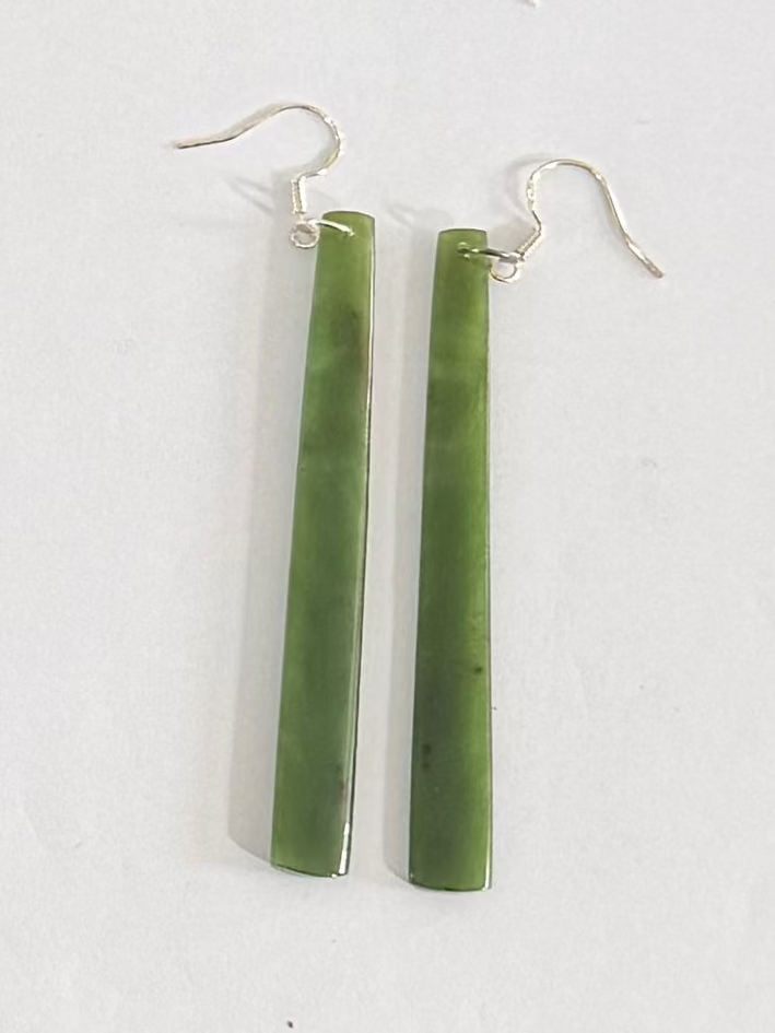 Greenstone earrings on a white background
