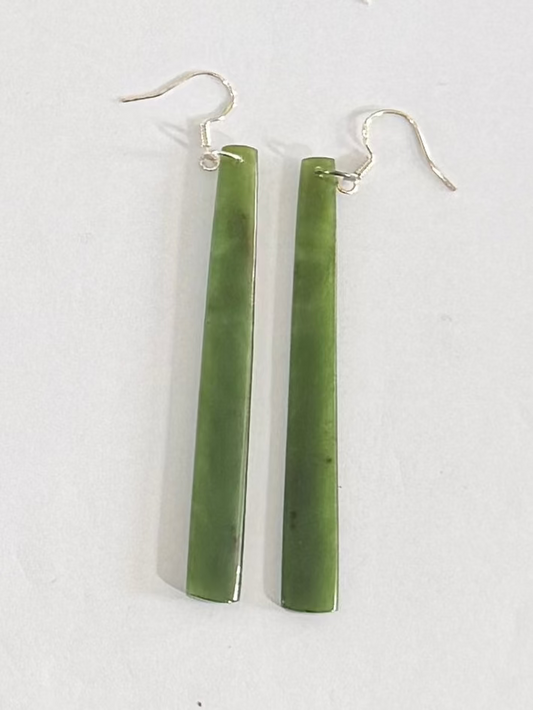 Greenstone earrings on a white background