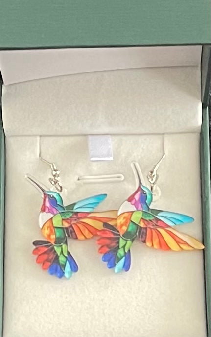 Colorful hummingbird-shaped earrings in a box