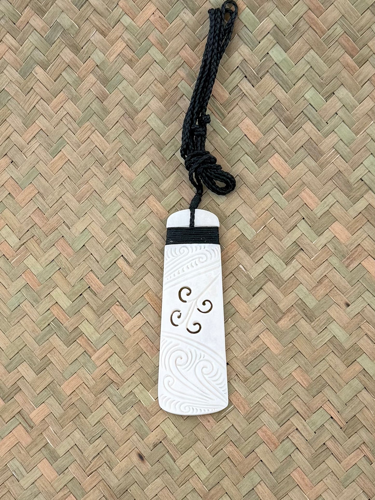 Carved beef bone toki pendant koru