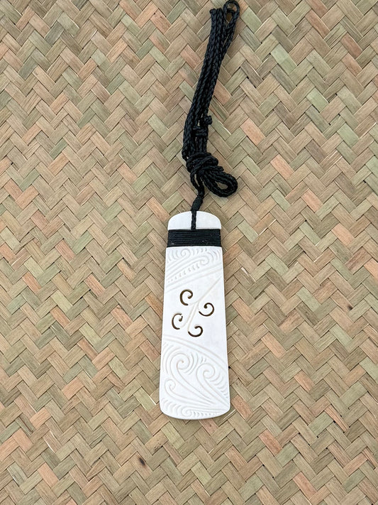 Carved beef bone toki pendant koru