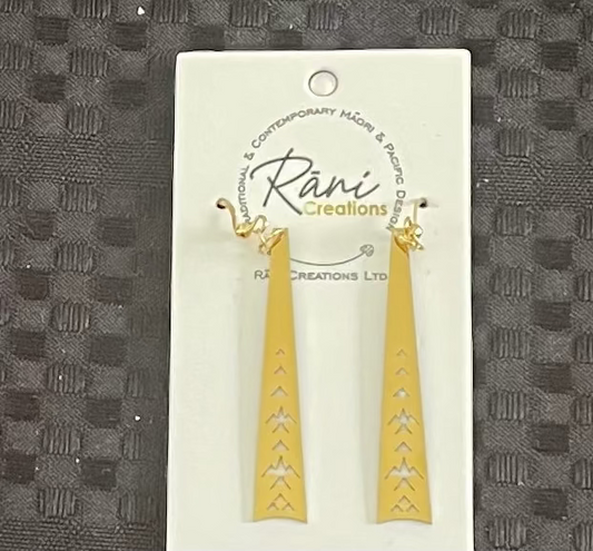 Gold Maori earrings on a Rani Creations branded card against a textured black background