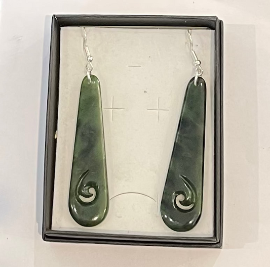 Greenstone earrings in a box on a white background