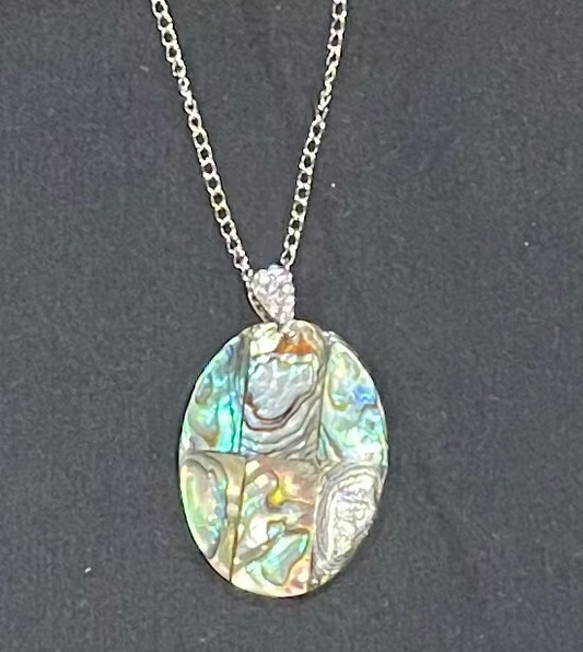 Necklace with an abalone shell pendant on a dark background