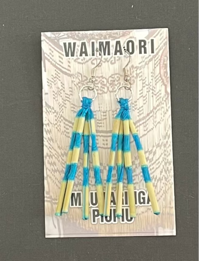 Pair of blue and yellow striped piupiu  earrings on a Waimaori branded card.