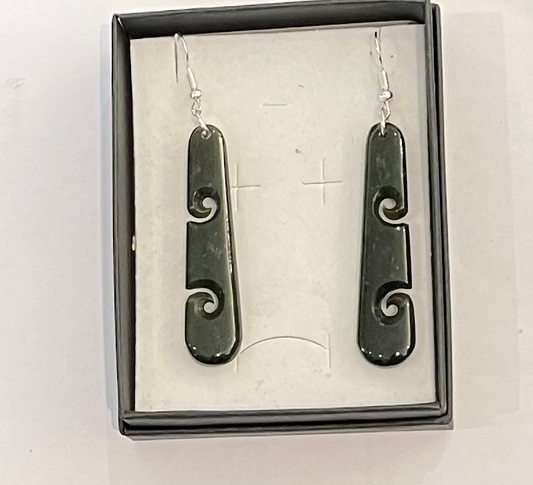 Pair of greenstone earrings with silver hooks in a box on a white background