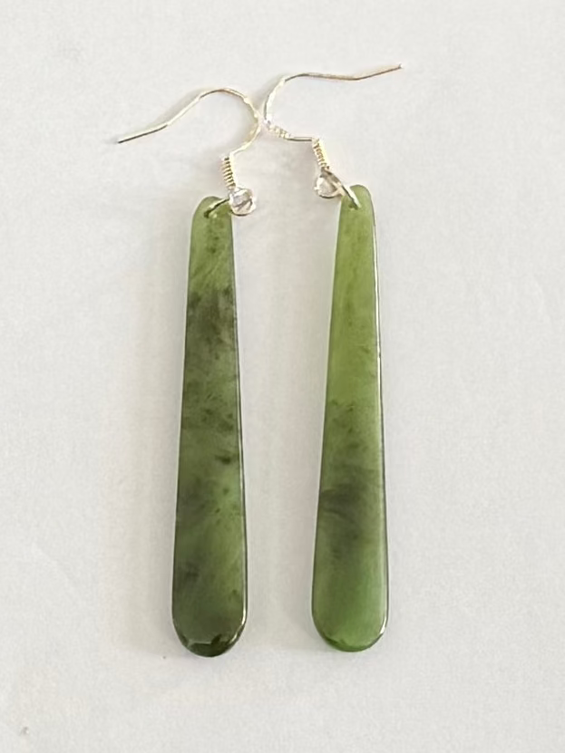 Greenstone  earrings on a light gray background