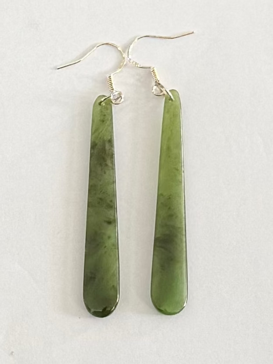 Greenstone  earrings on a light gray background