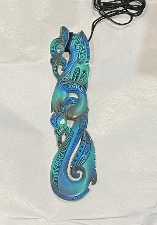 bone carving Blue and green decorative item on a white background