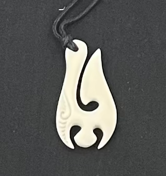 White bone pendant on a black background