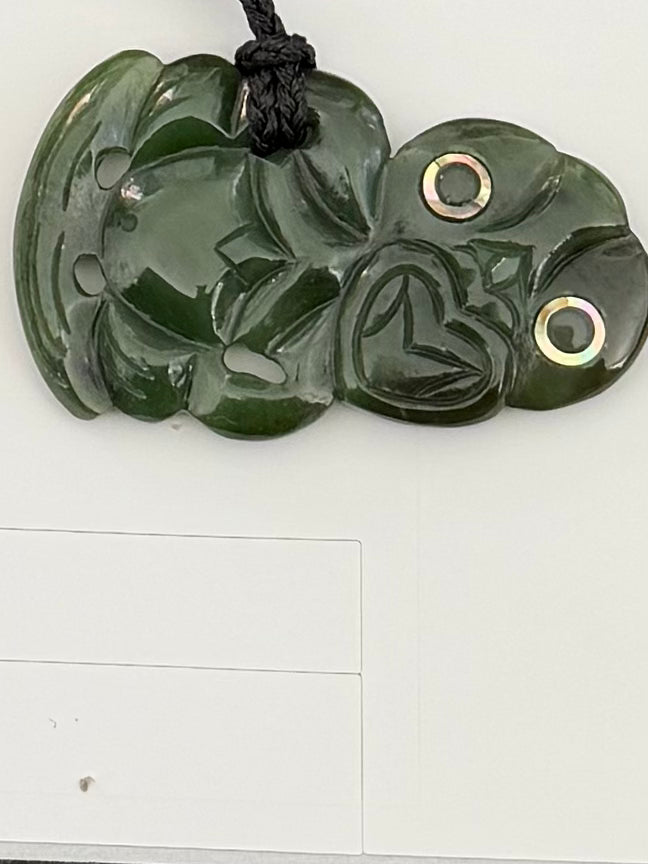 Sideway tiki greenstone pendant