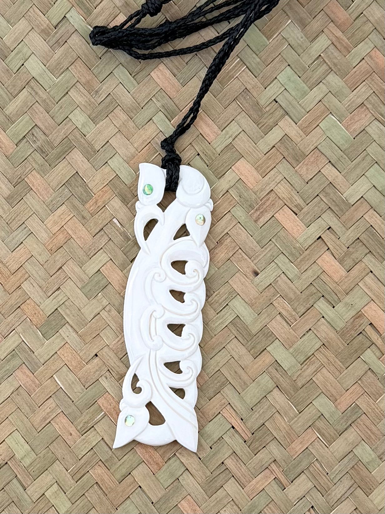 Carved beef bone pendant Manaia