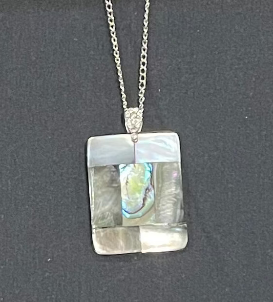 paua Necklace with a square pendant on a dark background