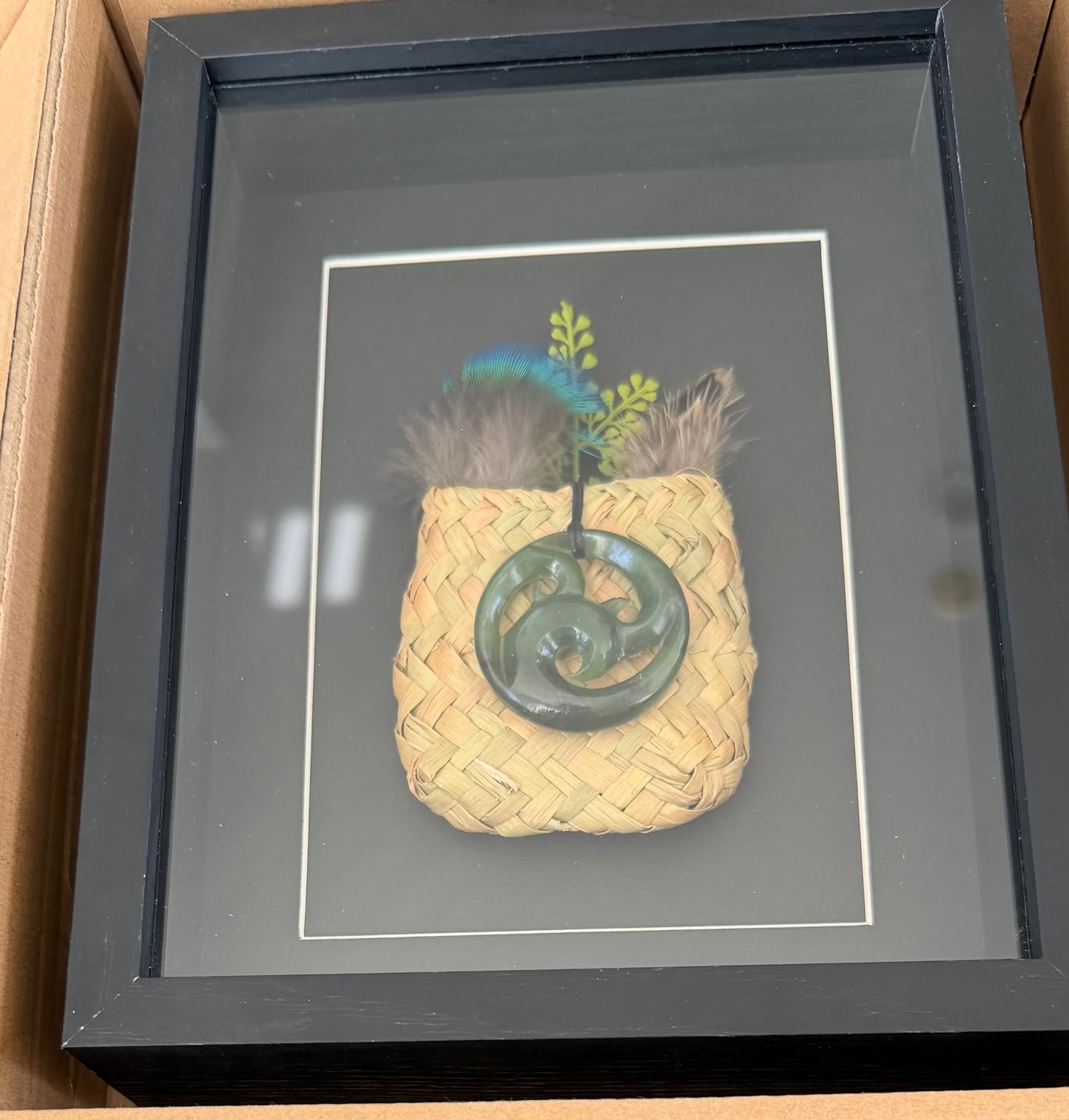 Greenstone Koru  in a Kete with Feathers Framed