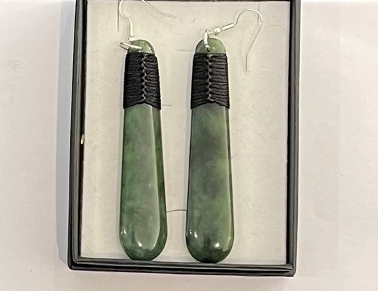 Greenstone earrings with black accents in a box on a white background