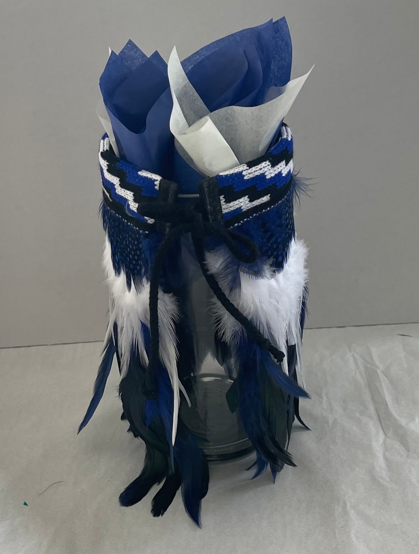 Decorative blue, white, and black feathered Korowai