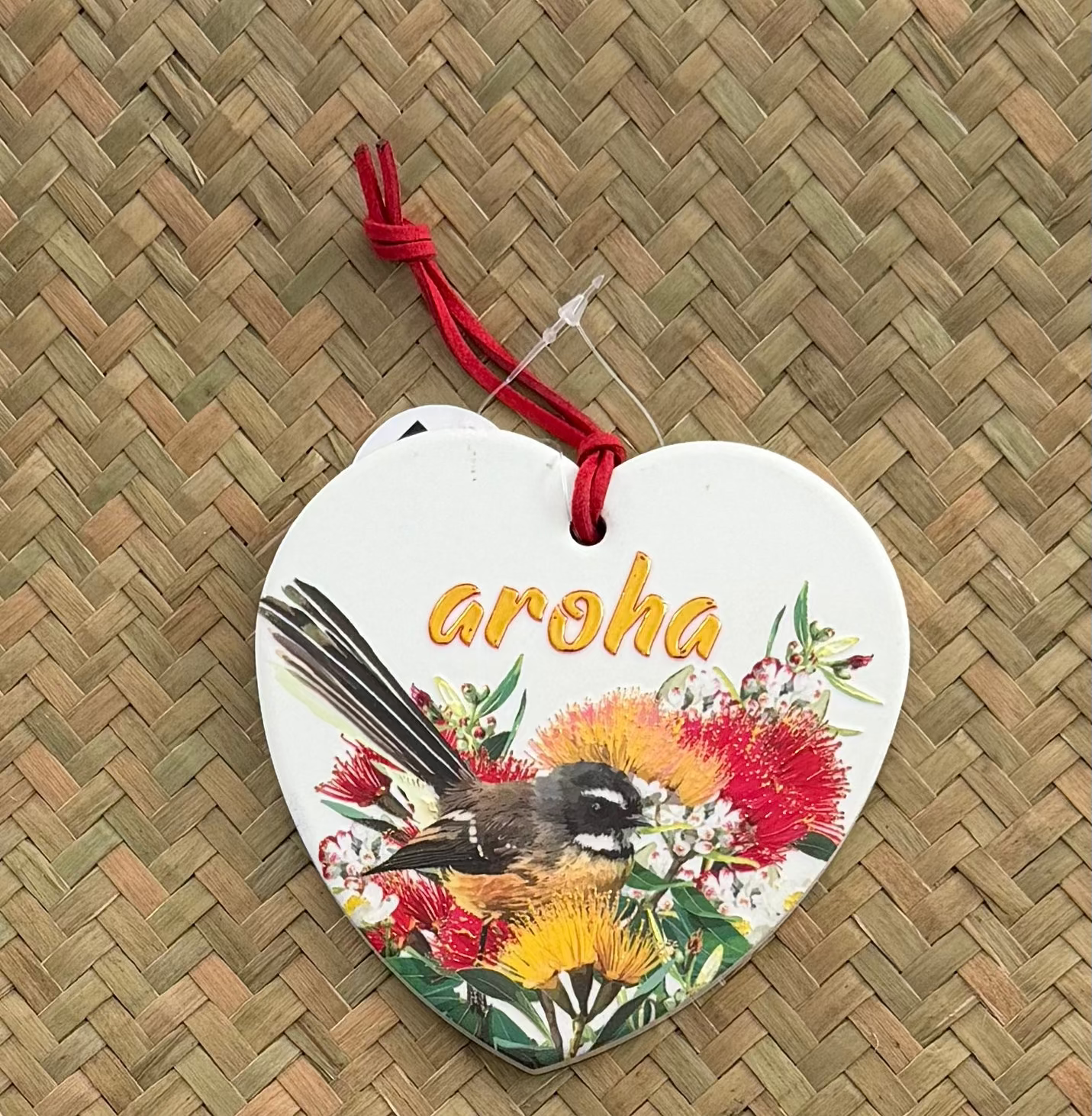 Ceramic 3D heart fantail in Pōhutukawa flowers with Aroha in gold on it