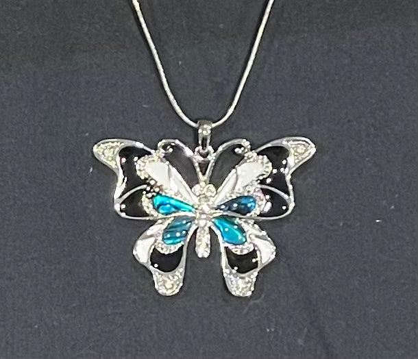 Butterfly-shaped pendant with blue accents on a dark background