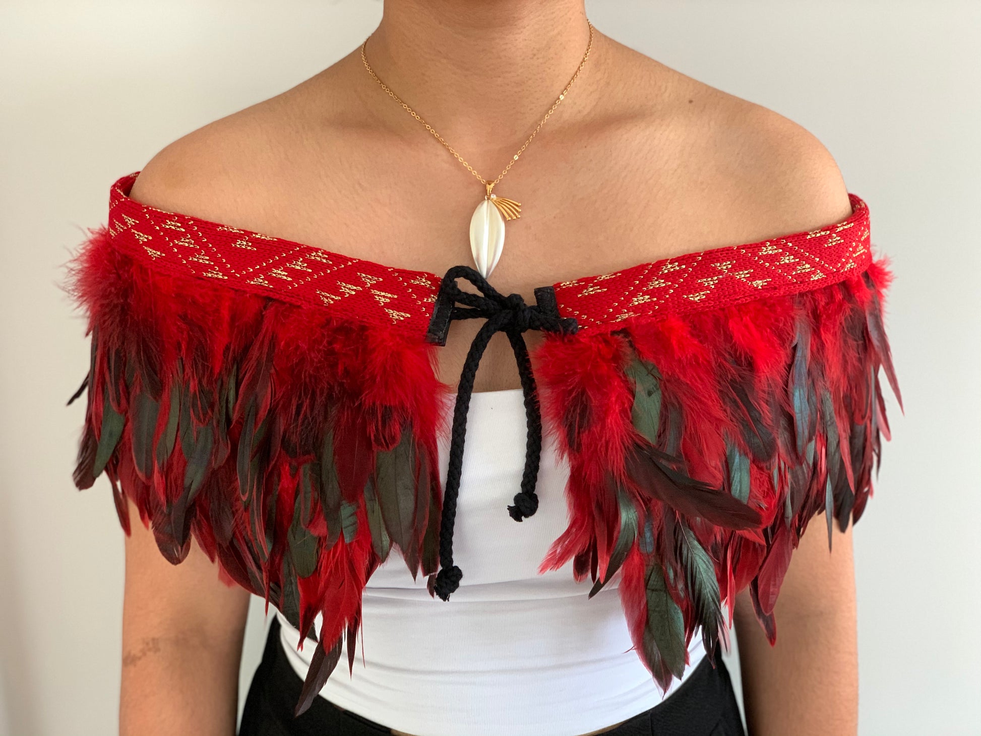 Red feathered evening Maori cape with gold thread band