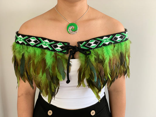 Green feathered Maori cape with taniko band