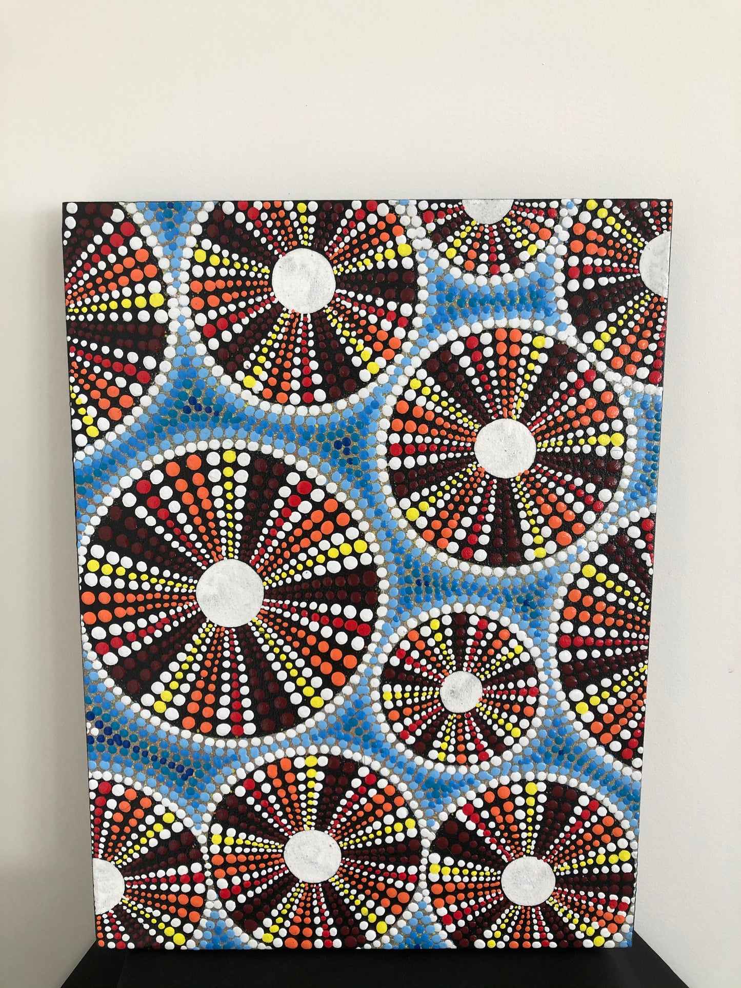 maori artwork features a Kina dot painting on canvas.