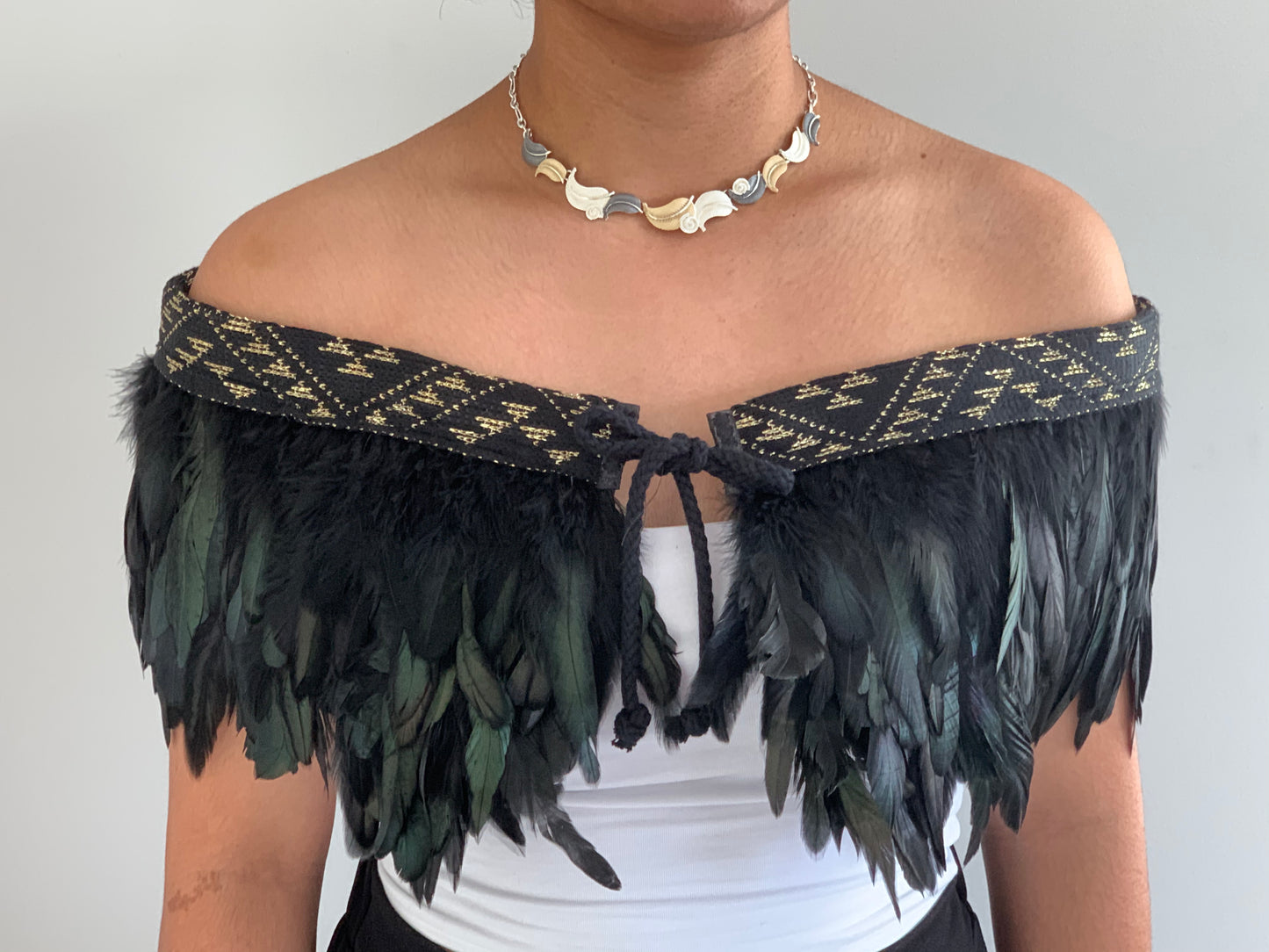 Black Evening feathered Maori cape with a gold threaded band