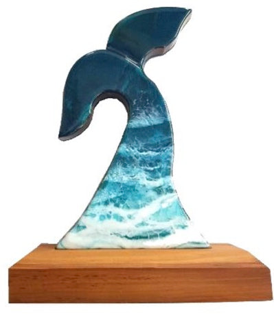 Large Wooden Rimu whales tail with blue resin on a base.